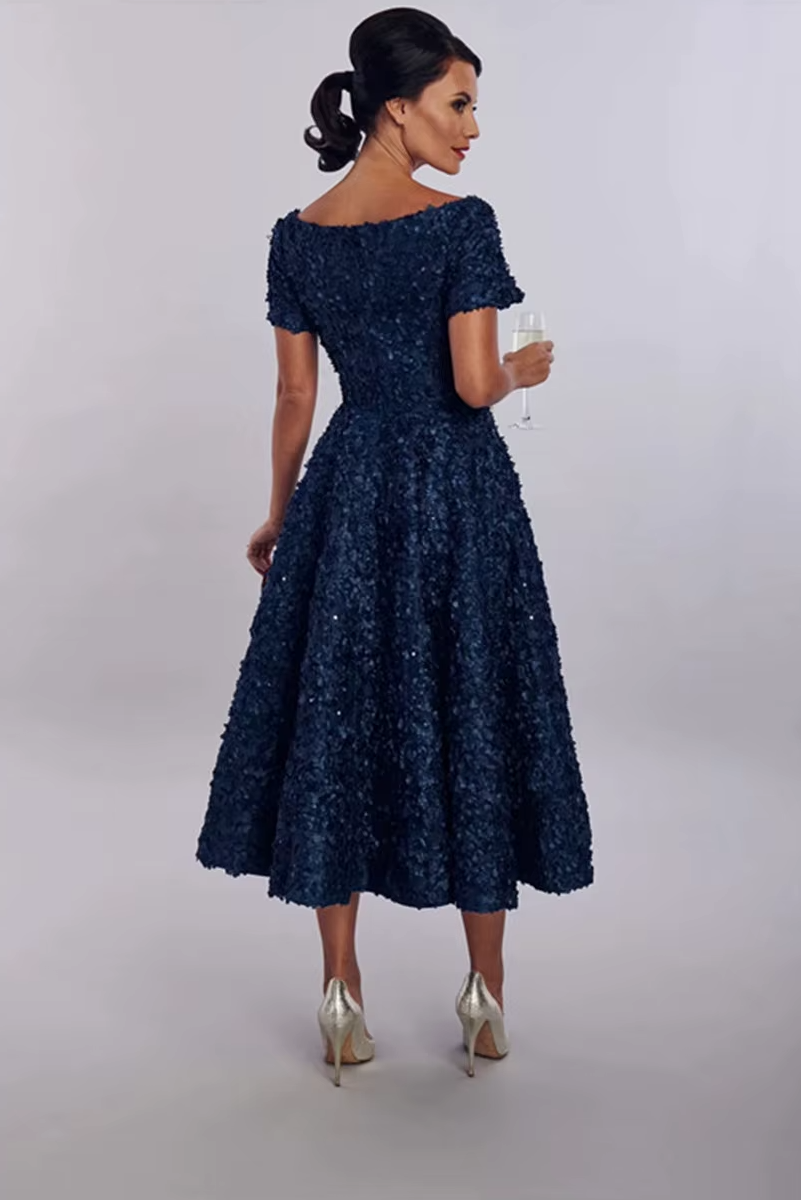 Woman wearing a navy blue lace dress with 'ToBeBridal' branding.