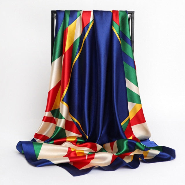 Royal Blue Designer Print Large Satin Silk Scarf will bring sophisticated elegance to any ensemble. Made from the finest silk, its beautiful pattern is perfect for wrapping elegantly around your neck, or for tying around a purse or hat.
